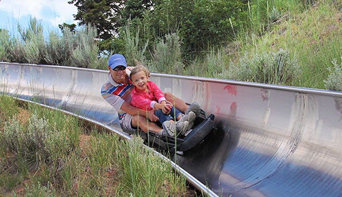 Alpine-slide_editorialonly_courtesyUtahOlympicLegacyFoundation_680 A father and daughter ride the alpine slide at Utah Olympic Park.