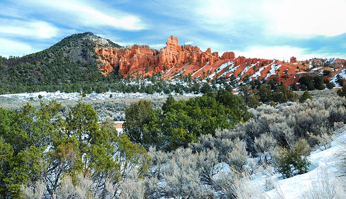 Bryce-distance-winter_DP_680 The pine and red rocks of Bryce Canyon spotted with snow.