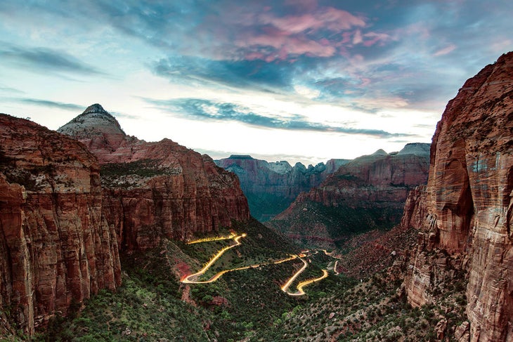 Zion Canyon Road with car lights streaming the way in Zion National Park