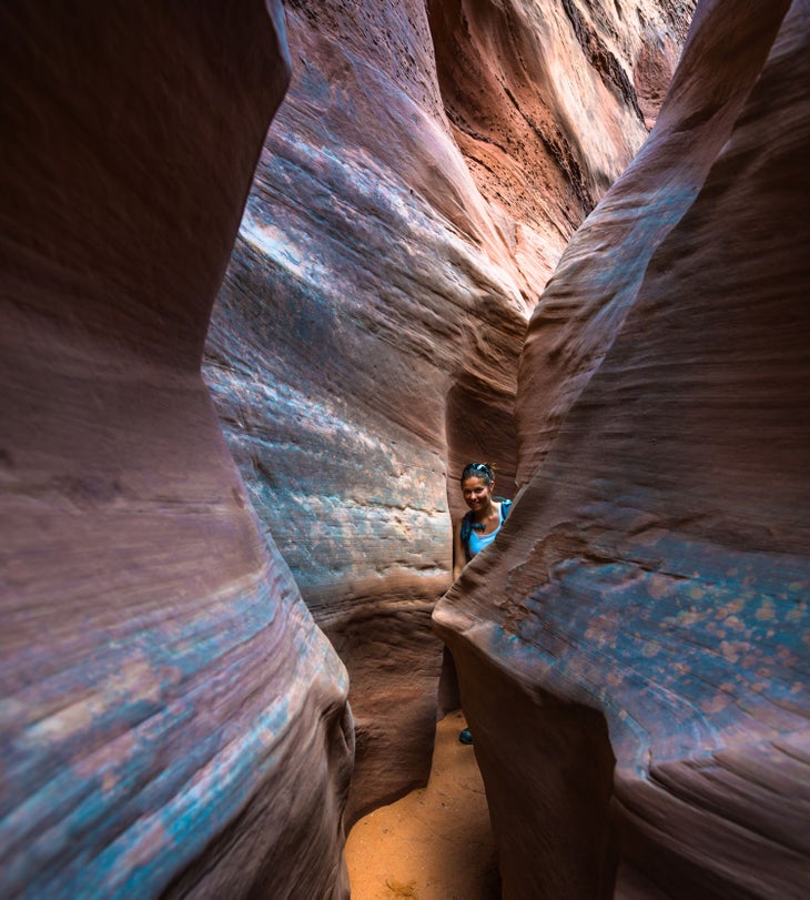A hiker in Spooky Gulch in Grand Staircase Escalente National Monument