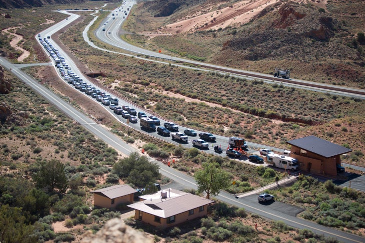 Park visitors lining up at the entrance to Arches National Park in Utah