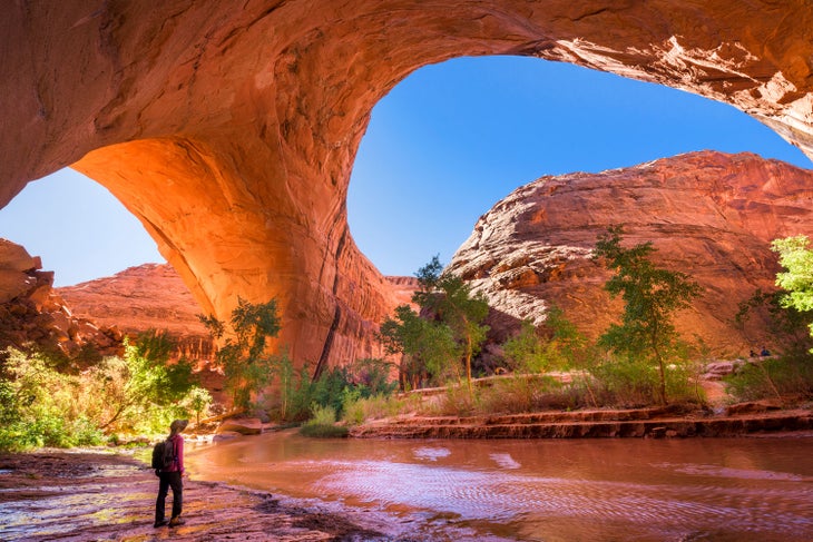 A hiker at Jacob Hamblin Arch in Coyote Gulch, Glen Canyon National Recreation Area