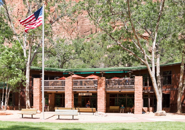 Red umbrellas on the patio of the Red Rock Grill at Zion Lodge