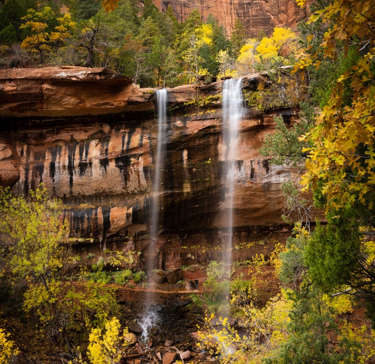 Autumn leaves surround the waterfalls on Zion National Park's Emerald Pools Trail